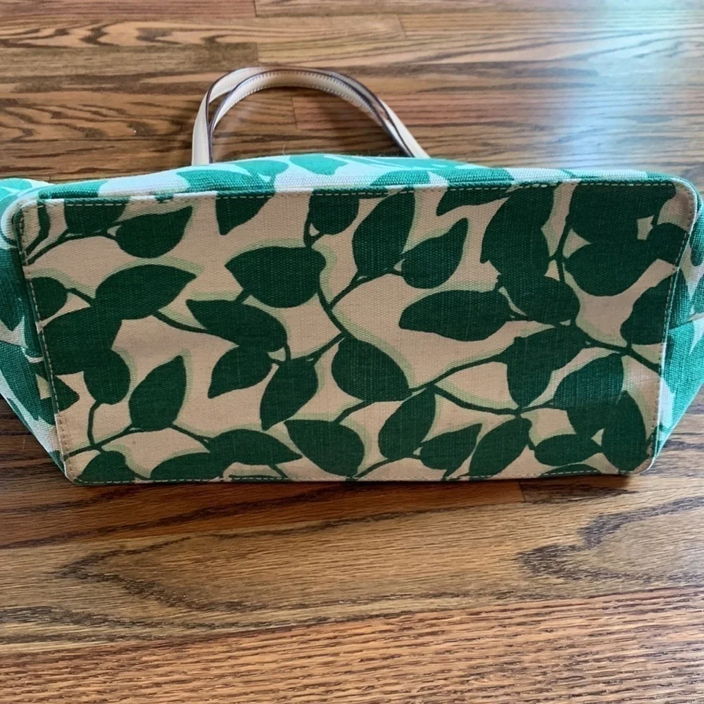 Kate Spade cream colored cloth tote with green leaf pattern.